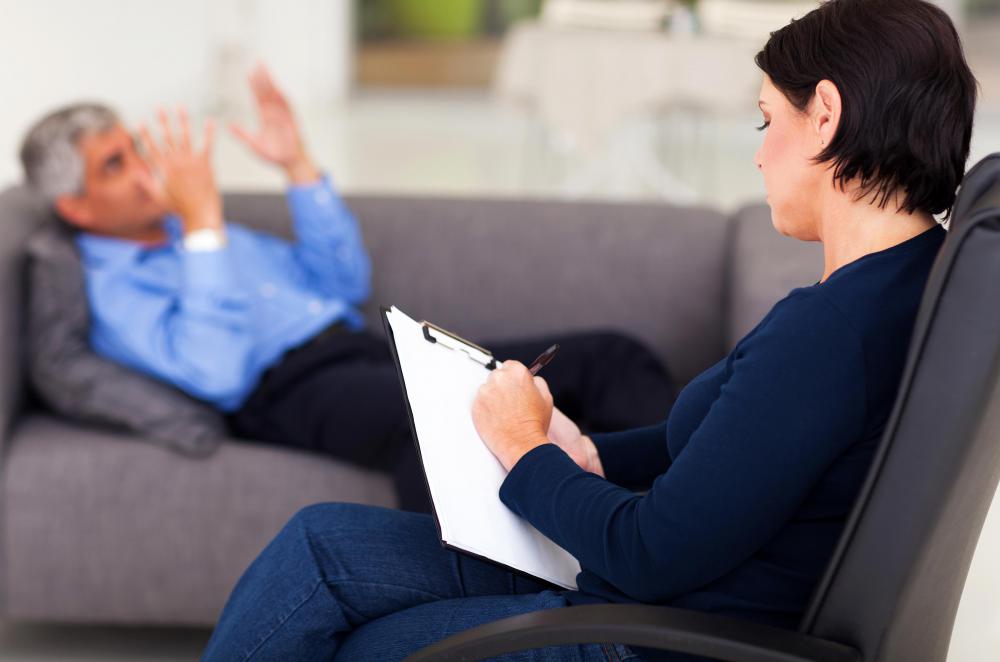 female-psychologist-in-black-with-male-patient-on-couch.jpg