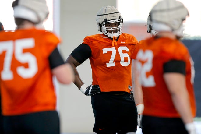 Oklahoma State's Caleb Etienne (76) is competing for the starting left tackle job.