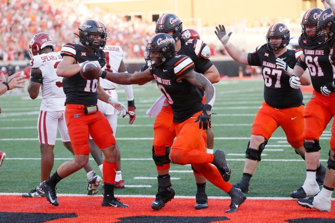 Oklahoma State Cowboys running back Ollie Gordon II (0) celebrates after scoring a touchdown during a Bedlam college football game between the Oklahoma State University Cowboys (OSU) and the University of Oklahoma Sooners (OU) at Boone Pickens Stadium in Stillwater, Okla., Saturday, Nov. 4, 2023. Oklahoma State won 27-24.