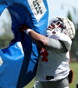 OSU defensive end Armstrong Nnodim runs a tackling drill during spring practice in Stillwater on April 16.